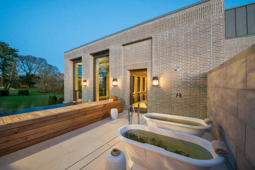 Two inviting seaweed baths overlooking the garden with views towards the Rock of Cashel — a signature Tipperary wellness experience