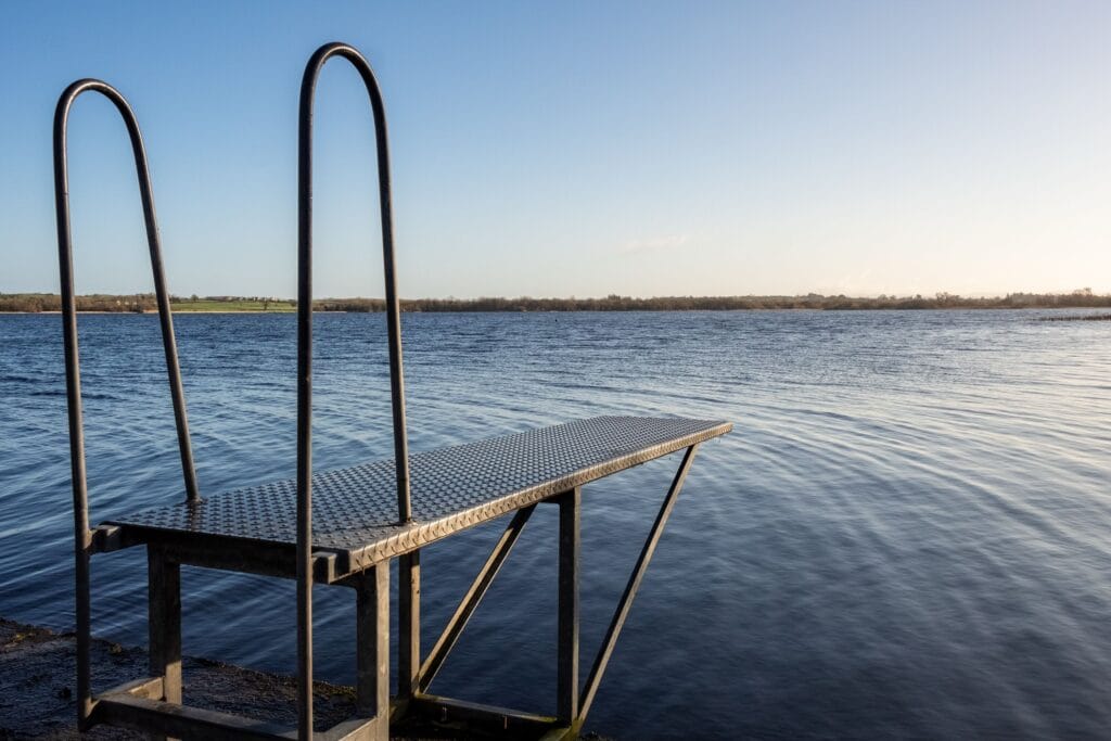 Metal diving board at Youghal Quay overlooking the cold, refreshing waters of Lough Derg — a classic Tipperary wellness lake swim spot